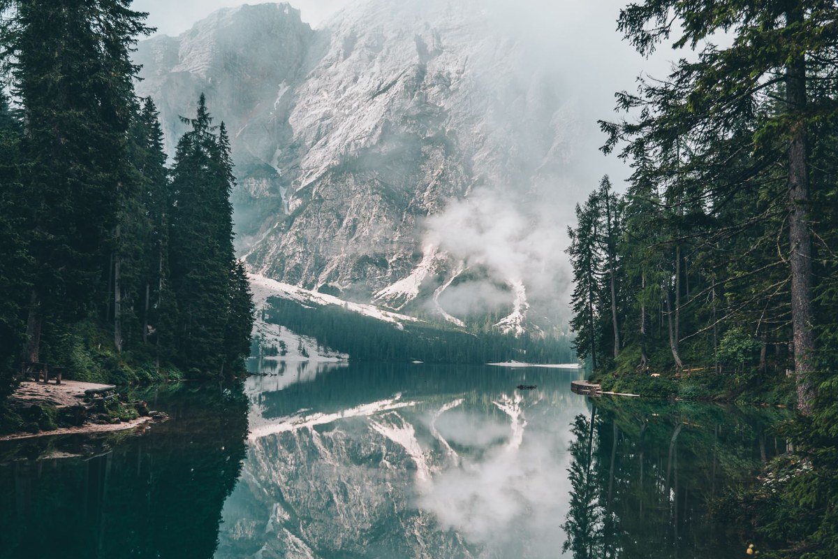 Jiuzhaigou Valley China turquoise lakes mist between pine trees and karst mountains