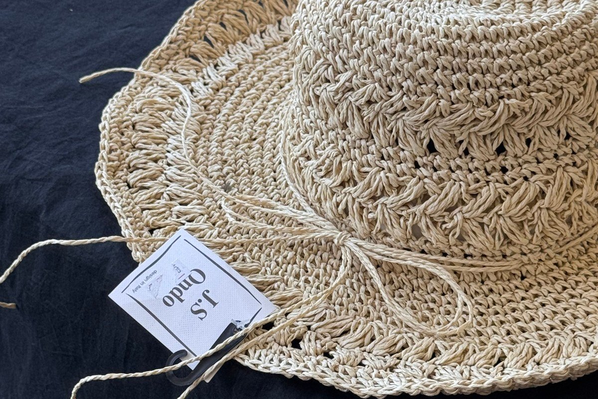 linen shirt straw hat woven tote wooden porch lake background
