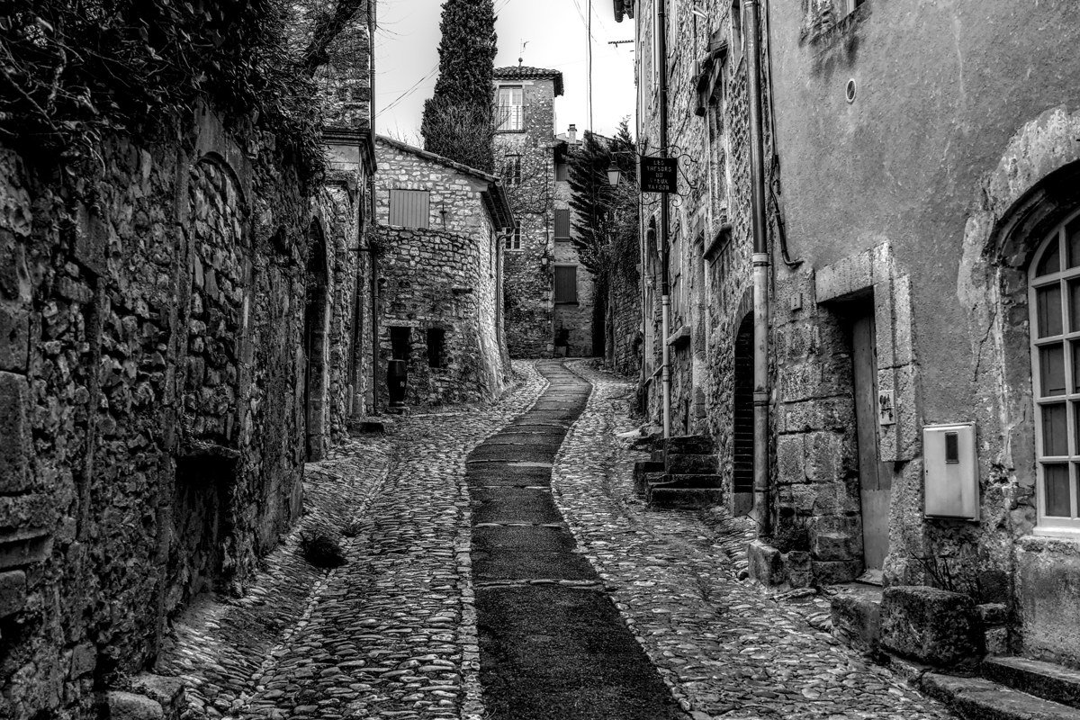 misty medieval European village stone streets cobblestones golden hour fog