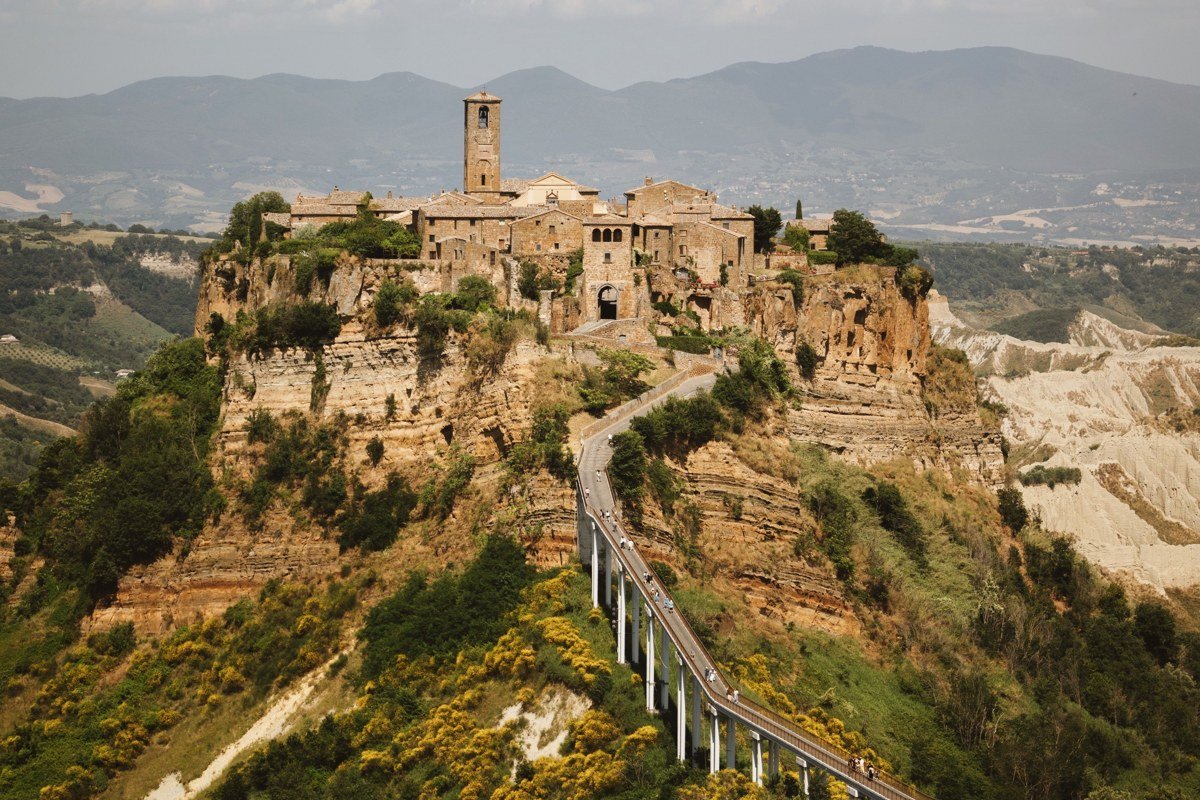 Civita di Bagnoregio Italy hilltop village eroding cliffs sunrise golden light