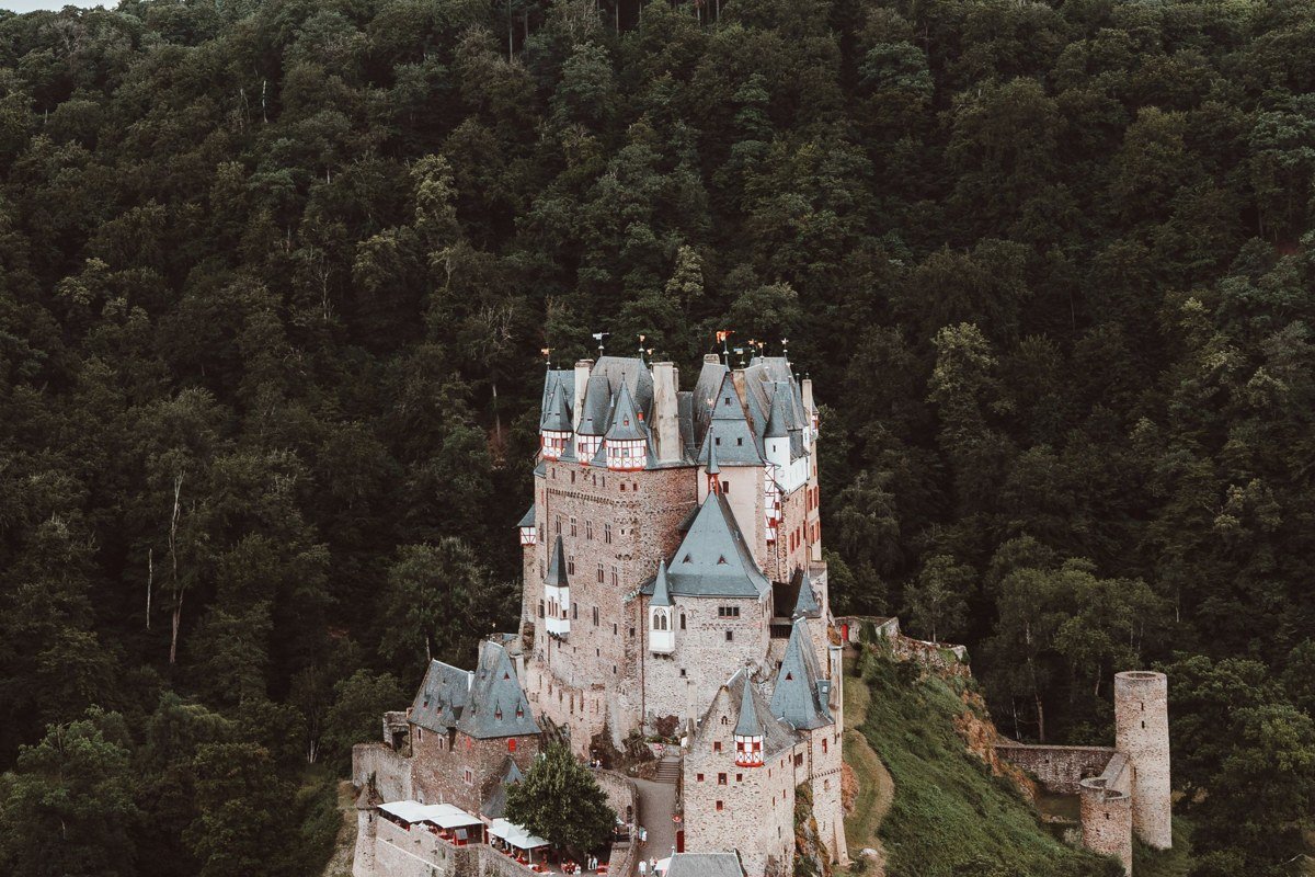 Burg Eltz Germany medieval castle forest valley river mist autumn leaves