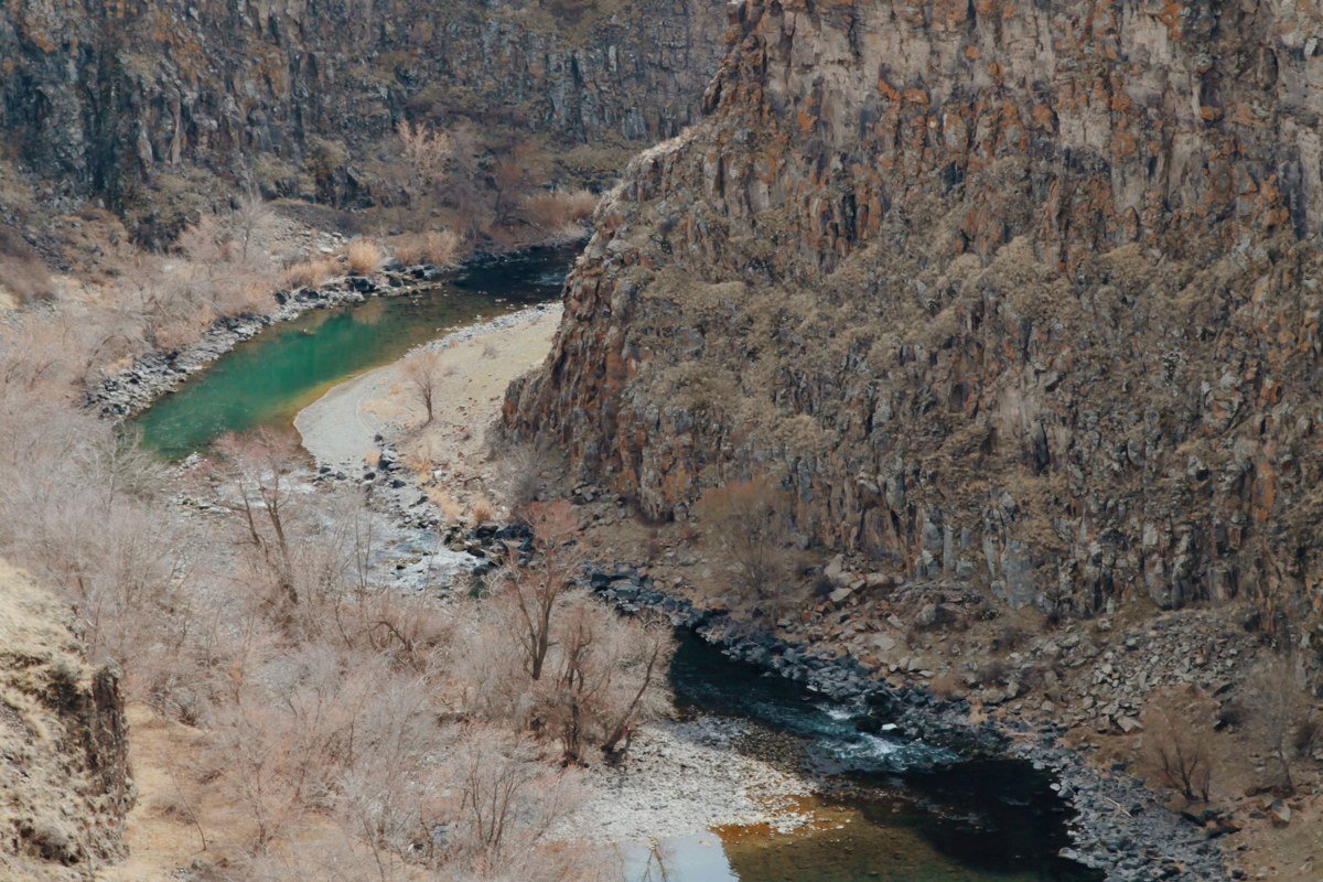 dramatic aerial view of wild river canyon with turquoise water and red rock walls