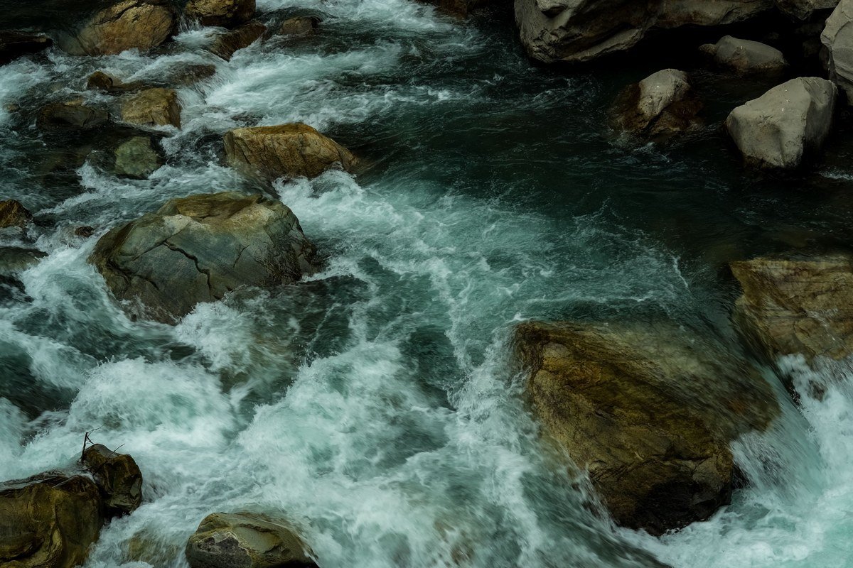 kayaker navigating massive white water rapids on turquoise Futaleufú River Chile surrounded by forest