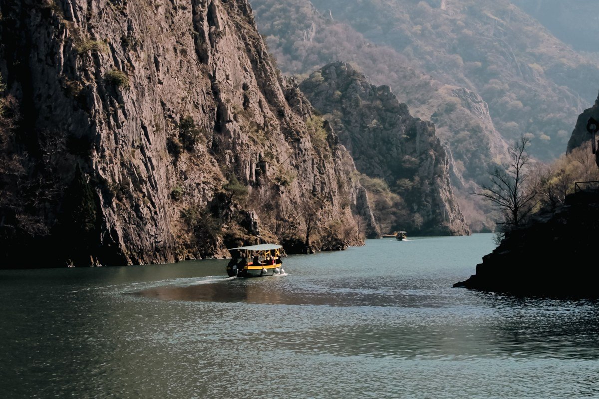 raft on remote Omo River Ethiopia with lush canyon walls and local wildlife on riverbank