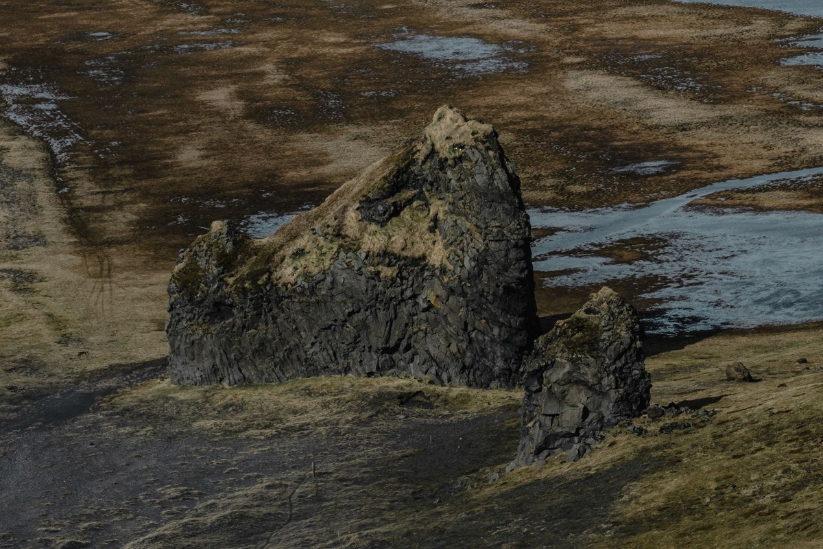Snaefellsjokull glacier volcano Iceland dramatic coastline black lava rock moody clouds