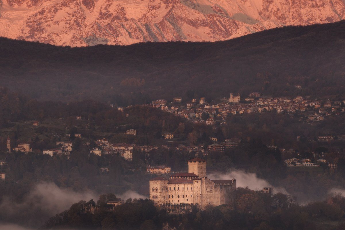misty medieval Eastern Europe fortress valley at dawn panoramic view