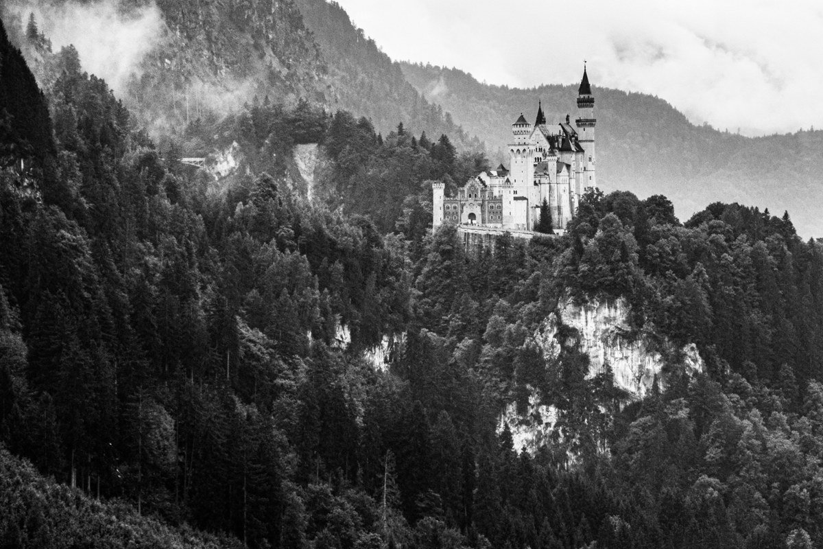 Peles Castle Romania Sinaia valley forested mountains autumn mist