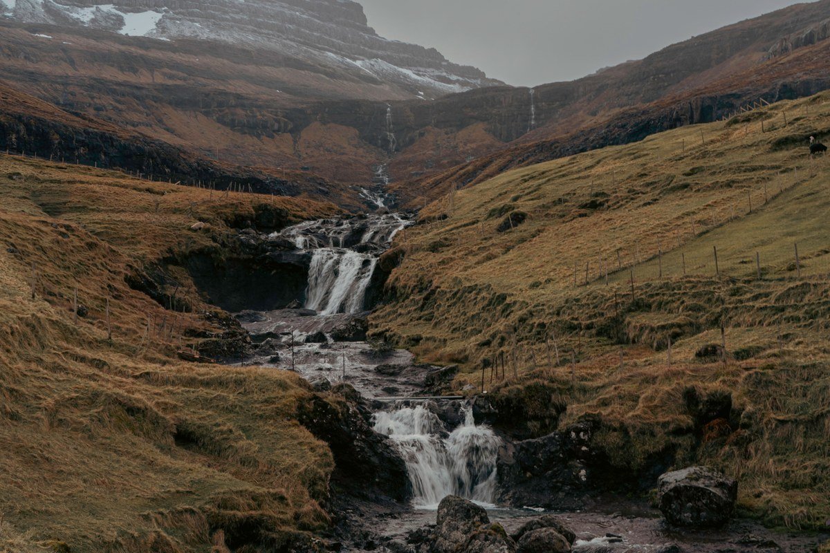 Mulafossur waterfall Gasadalur Faroe Islands misty cliff ocean drop