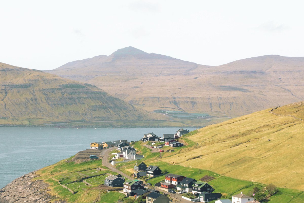 Kallur lighthouse Kalsoy Faroe Islands foggy green peninsula cliffs