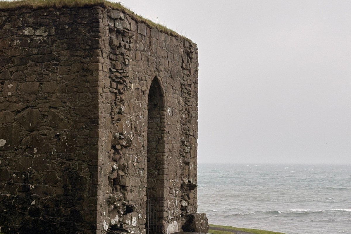 Drangarnir sea arch Vagar Faroe Islands misty ocean dramatic basalt arch