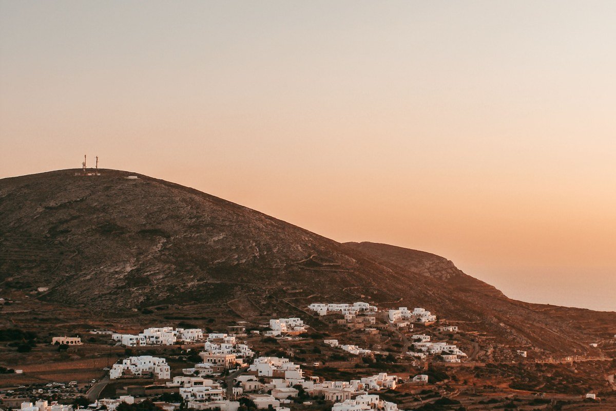 Folegandros Chora whitewashed village perched on dramatic cliff edge above deep blue Aegean sea