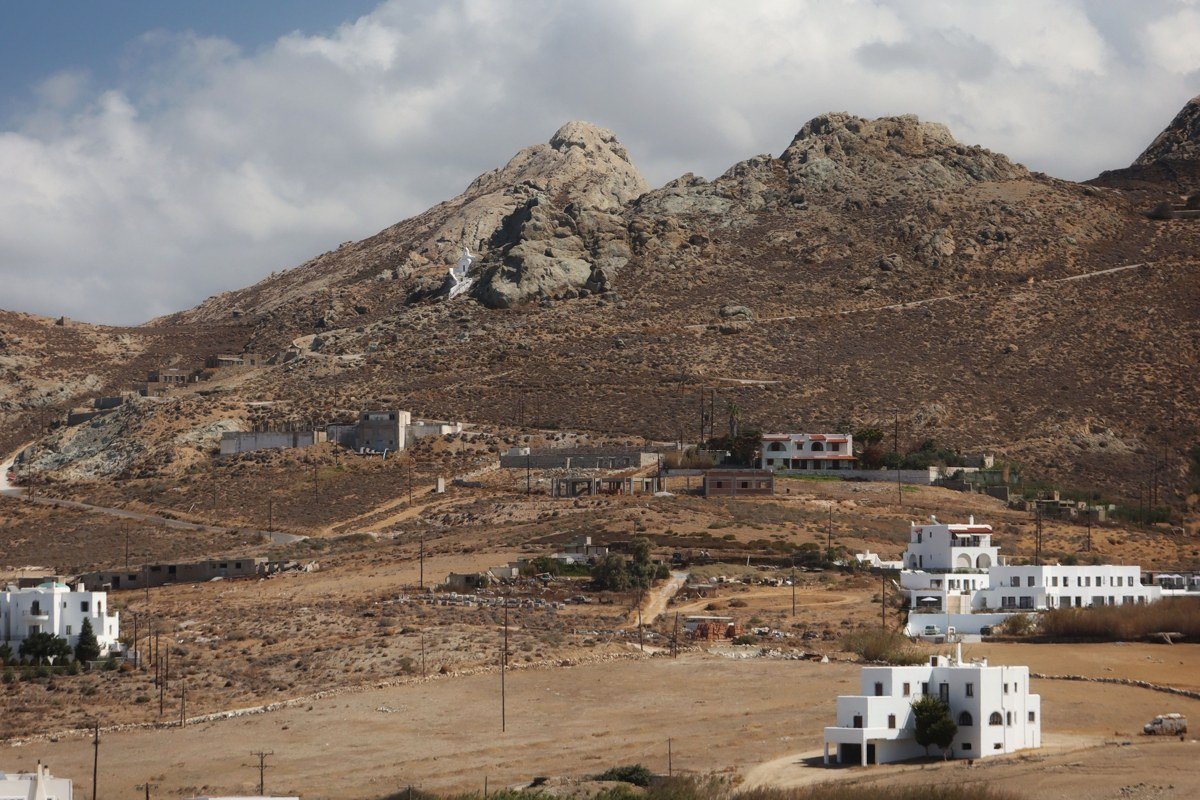 Apeiranthos Naxos marble-paved village street with stone arched passages and mountain backdrop