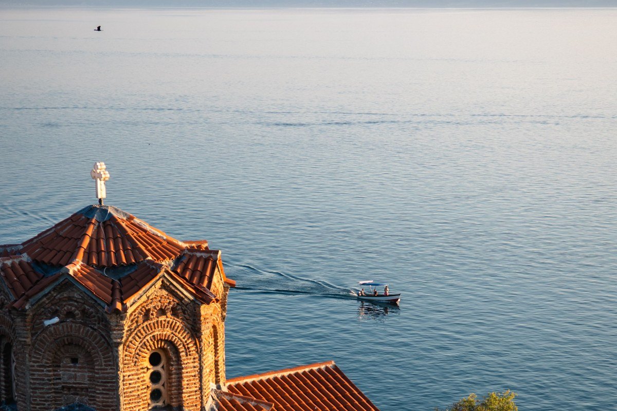 Kastoria Macedonia Greece Byzantine churches lakeside town reflected in still lake water at dusk