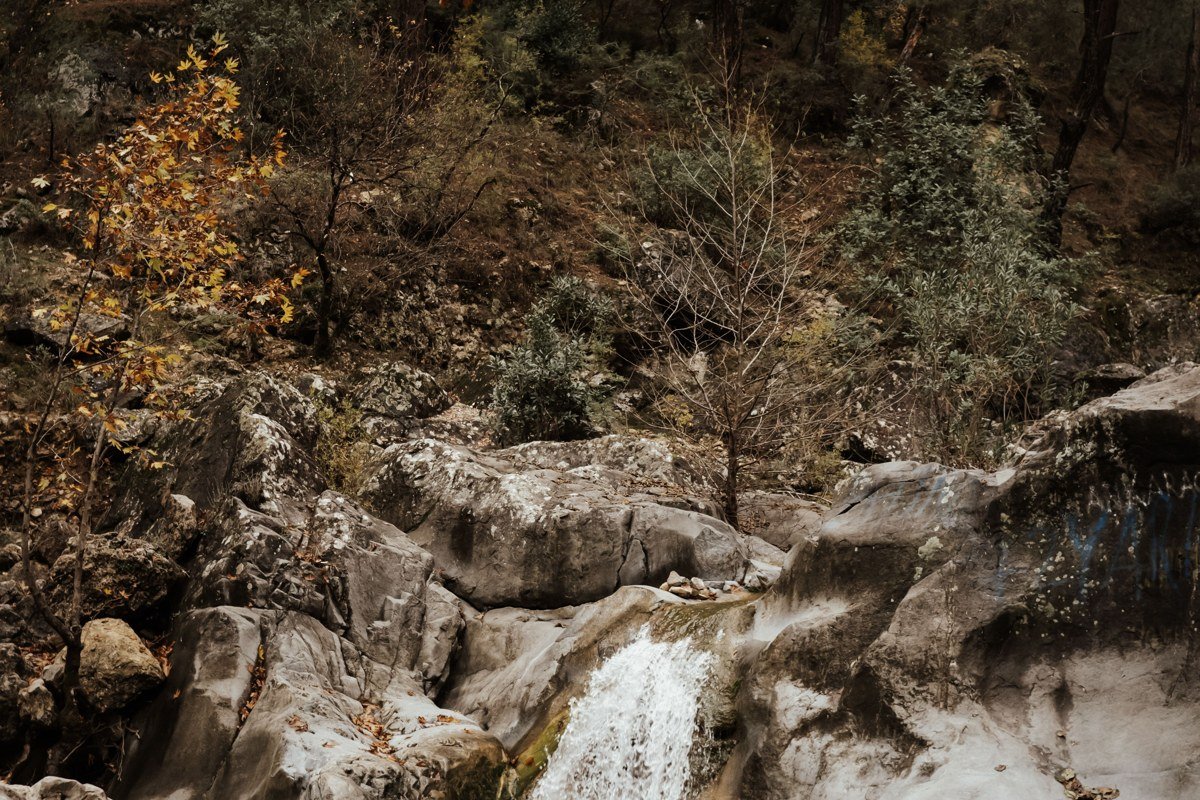 Samothrace Greece wild mountain waterfall cascading through dense forest into natural rock pool
