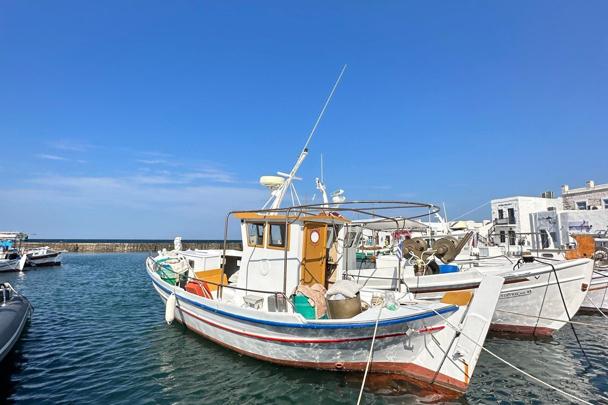 Halki island Greece neoclassical pastel harbour buildings fishing boats Nimporio