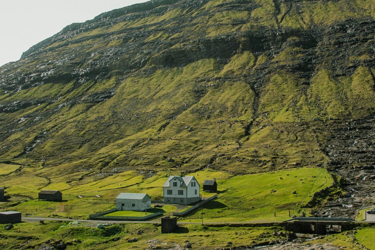 Funningur Faroe Islands Eysturoy fjord village church green hillside mist