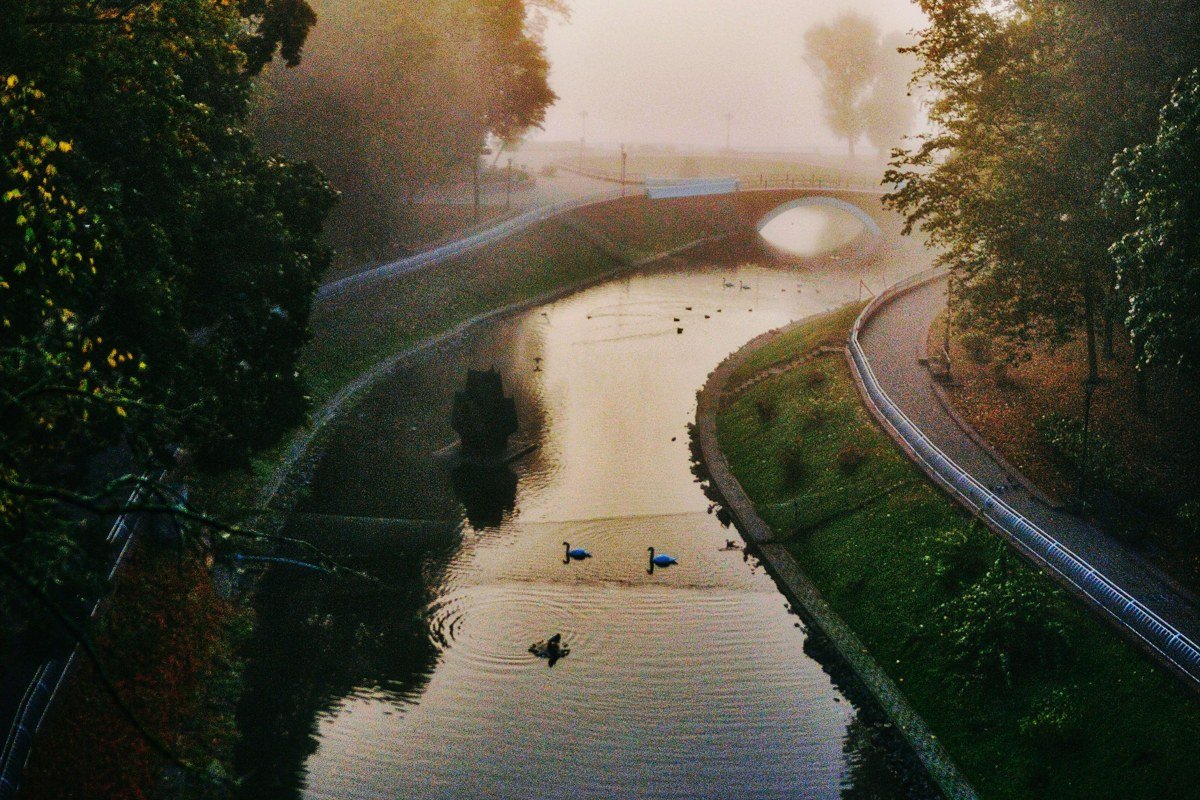 The Siuslaw River Bridge at Florence in morning fog, its art deco towers reflected in the calm water below, the old town visible on the far bank