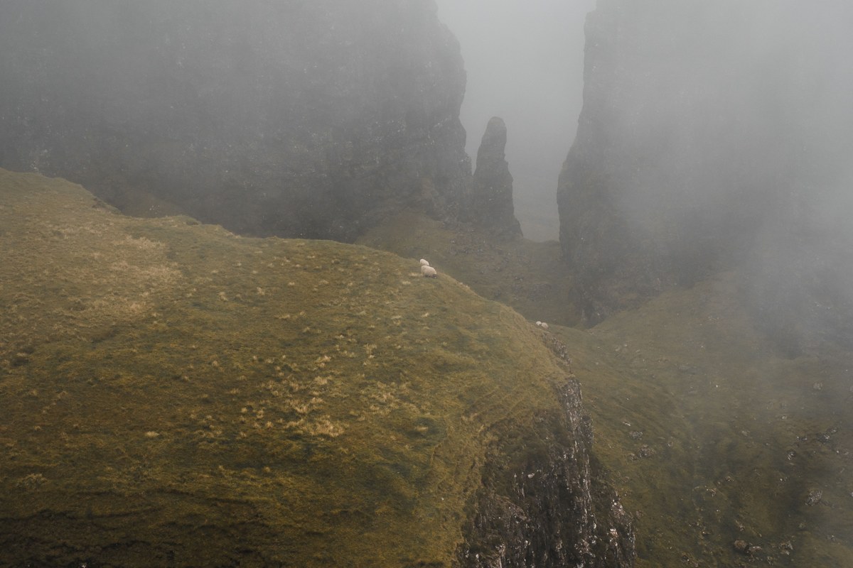 Simien Mountains Ethiopia trekker on cliff edge gelada baboons dramatic escarpment fog