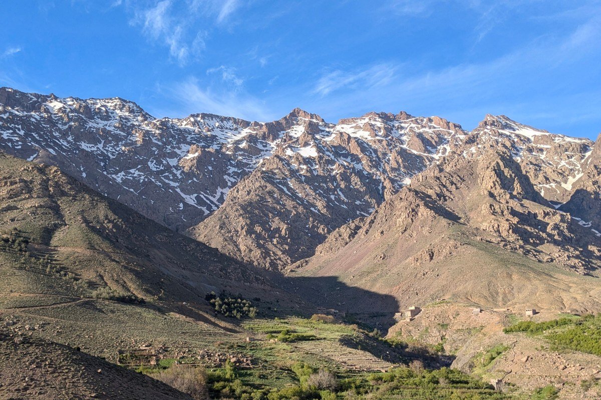 Mount Toubkal Morocco climber rocky ridge summit snow Atlas Mountains blue sky
