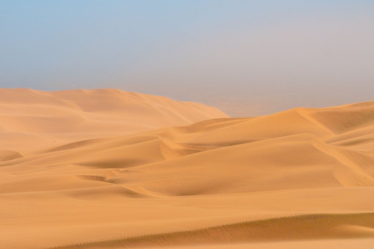 Skeleton Coast Namibia shipwreck rusted hull desert fog dunes Atlantic Ocean
