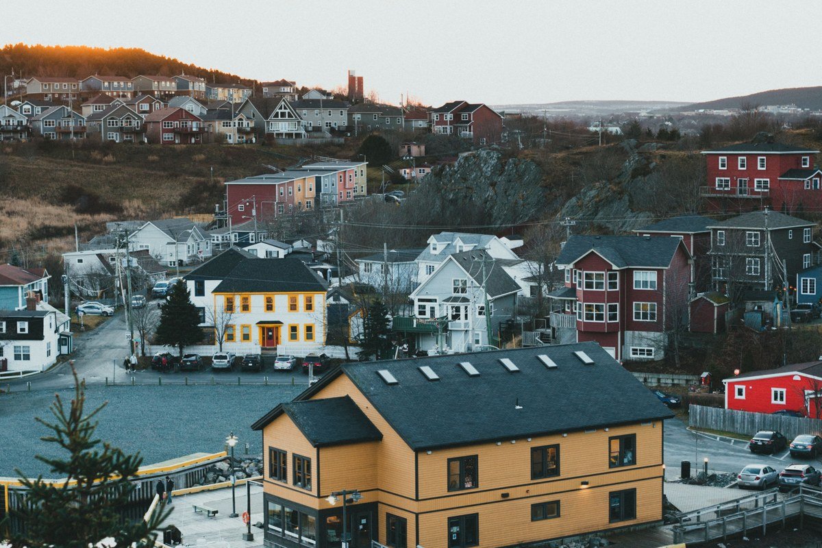 Husavik Iceland colorful church harbor village whale watching boats evening golden light