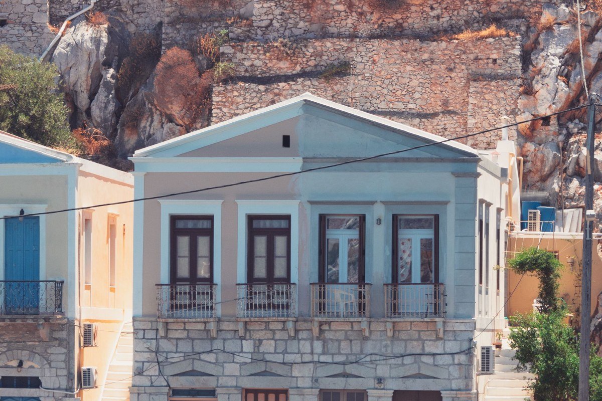 Kastellorizo Megisti island Greece colorful neoclassical waterfront harbor blue water Ottoman fountain