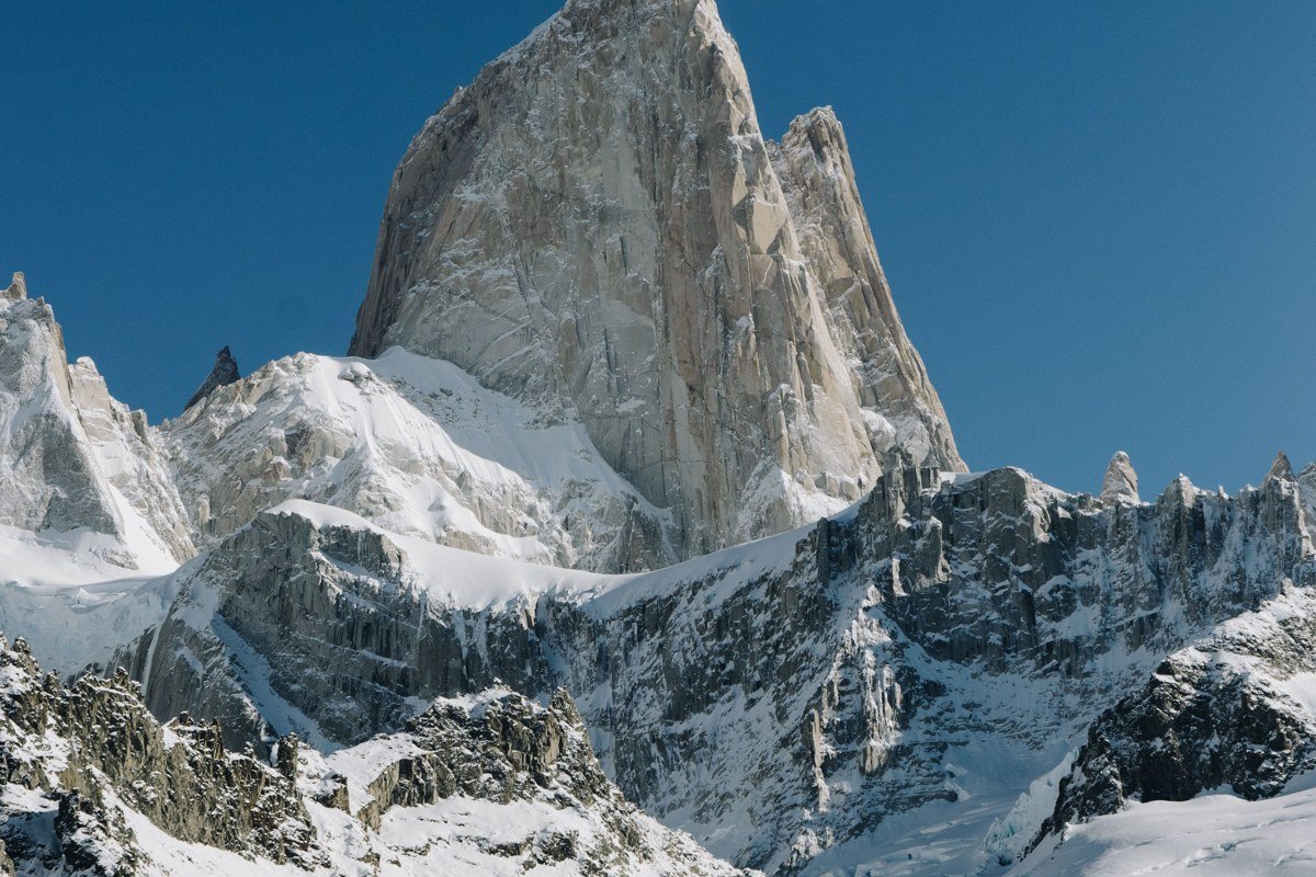 Monte Fitz Roy Argentina sunrise pink alpenglow granite spire trekker silhouette