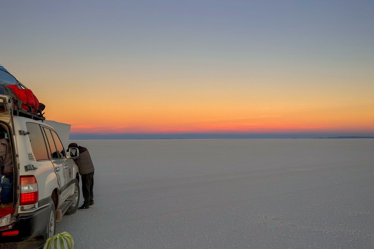 Salar de Uyuni Bolivia wet season water edge shallow reflection salt hexagon submerged