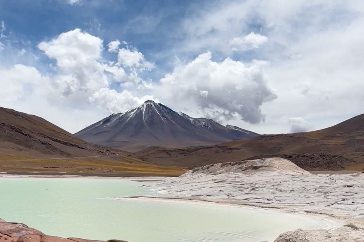 Tunupa Volcano Bolivia salt flat edge snow capped volcano reflection wet season lake