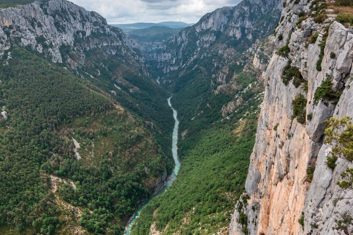Southeast Asia jungle canyon river adventure aerial view lush green limestone cliffs