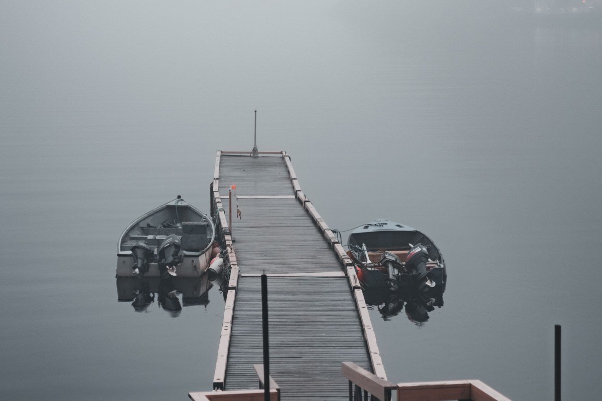 Seeley Lake Montana dock wooden boat house morning mist pines wilderness