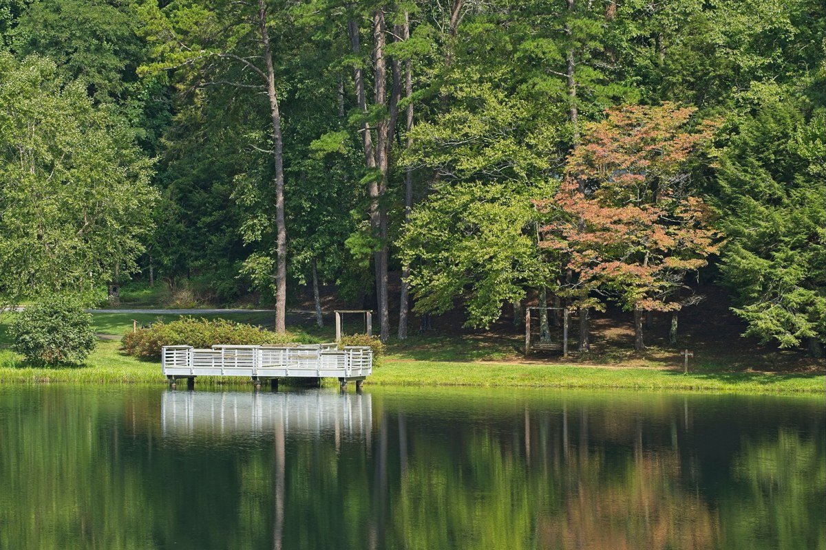 Blairsville Georgia Vogel State Park lake reflection fall foliage Blue Ridge Mountains with wooden dock foreground