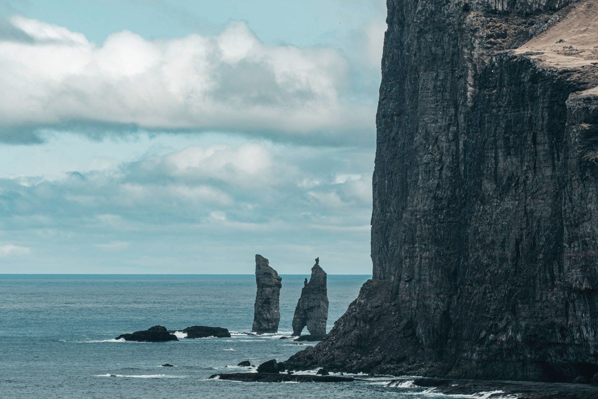 Faroe Islands aerial view dramatic green cliffs ocean mist