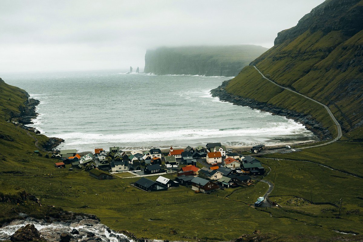 Saksun Faroe Islands tidal lagoon green valley turf roofed church dramatic clouds
