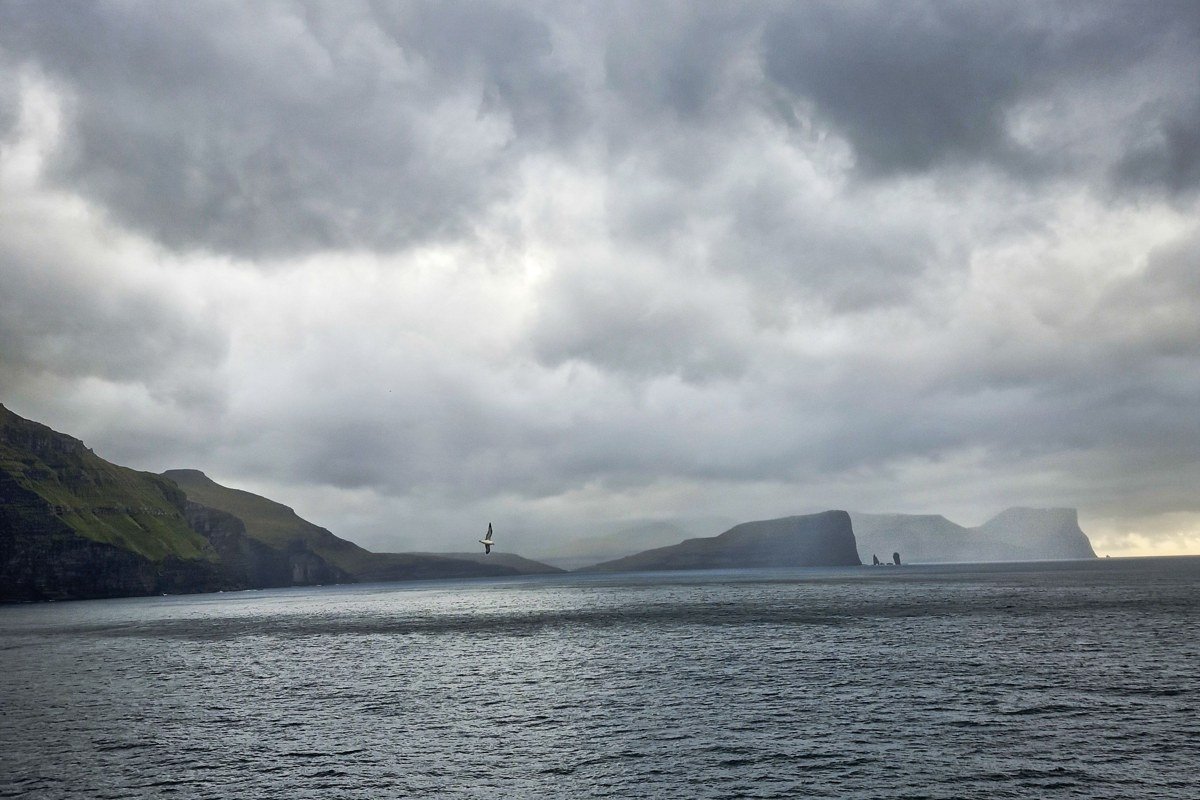 Drangarnir sea stacks Faroe Islands Tindhólmur ridge dramatic sunset silhouette