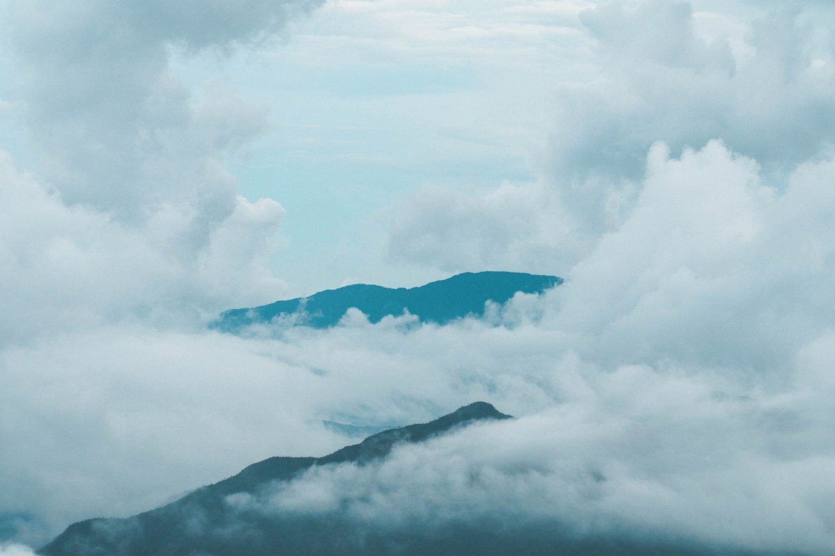 Pico mountain Azores volcanic summit above clouds misty aerial view