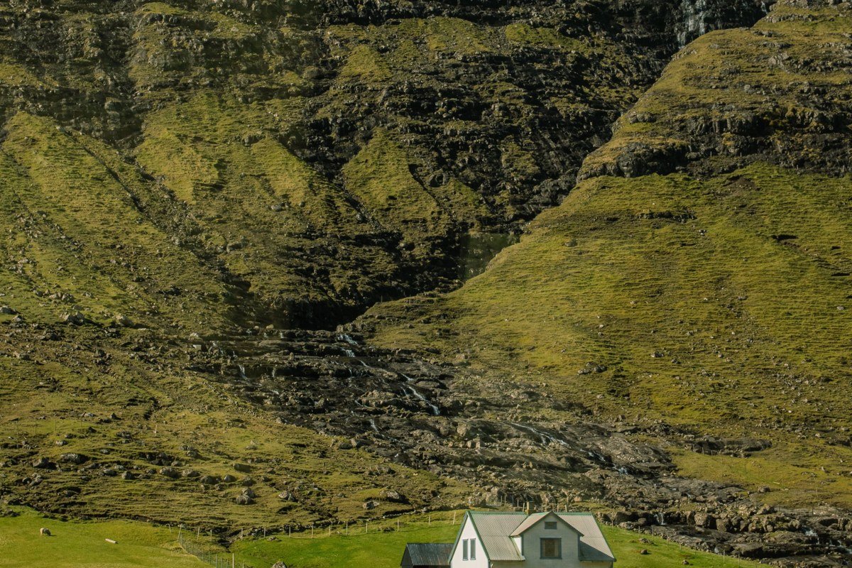 Faroe Islands dramatic fog-draped sea cliffs aerial view