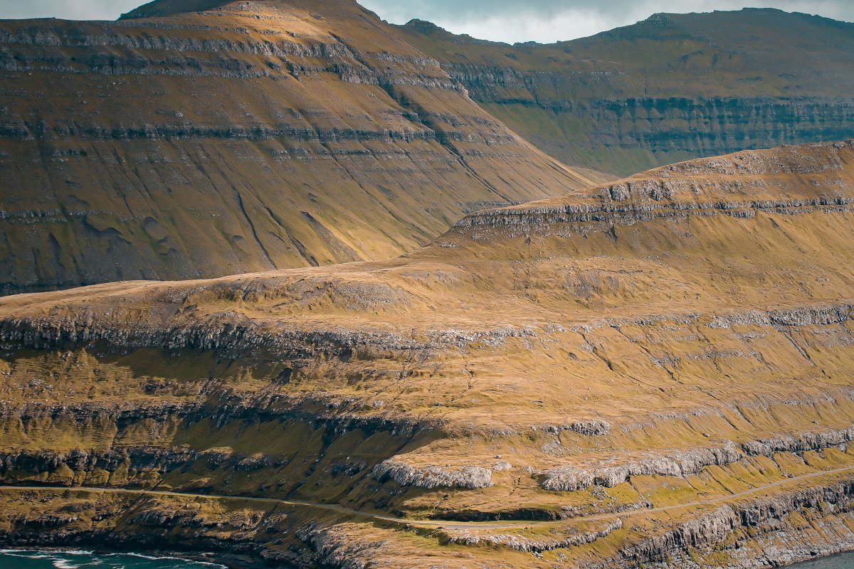 Gasadalur Faroe Islands waterfall village green cliffs fog