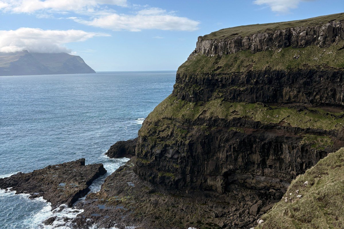 Koltur island Faroe Islands uninhabited green cliffs sea mist