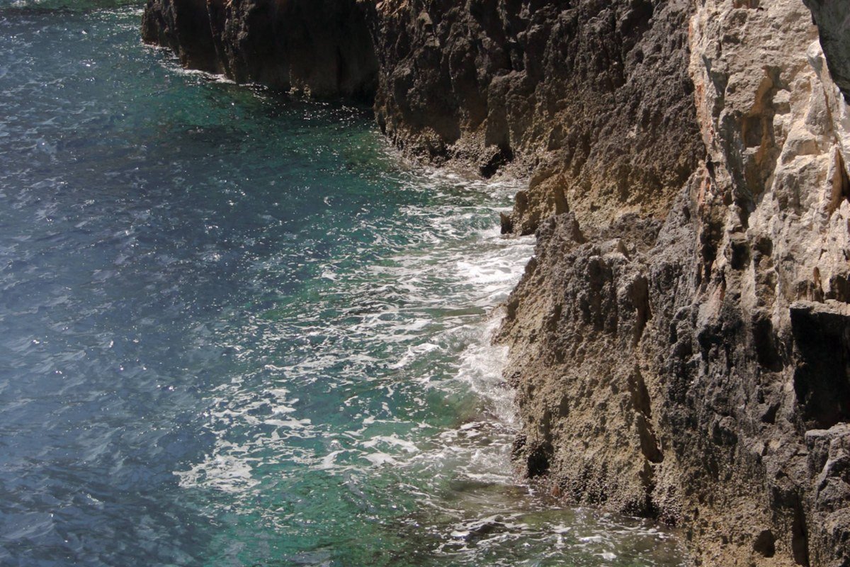 Crete south coast dramatic limestone cliffs turquoise sea aerial view