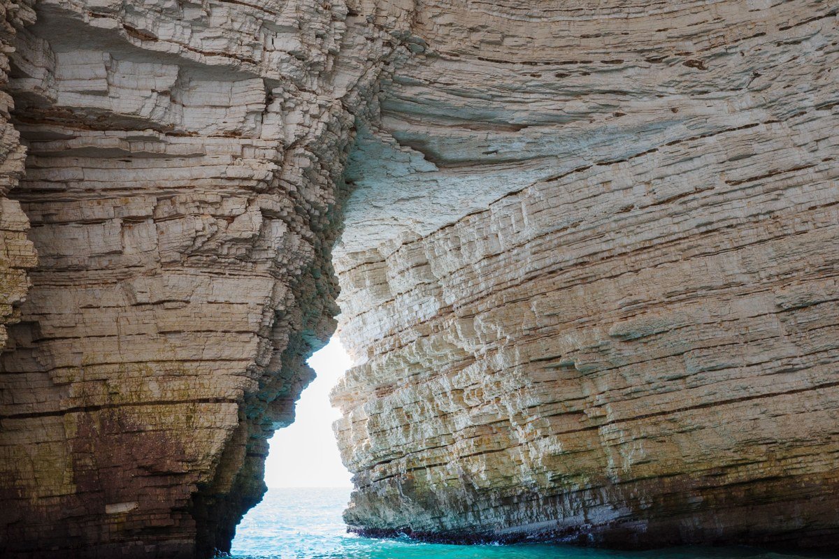 Milos Greece Kleftiko white volcanic sea caves turquoise water boat trip