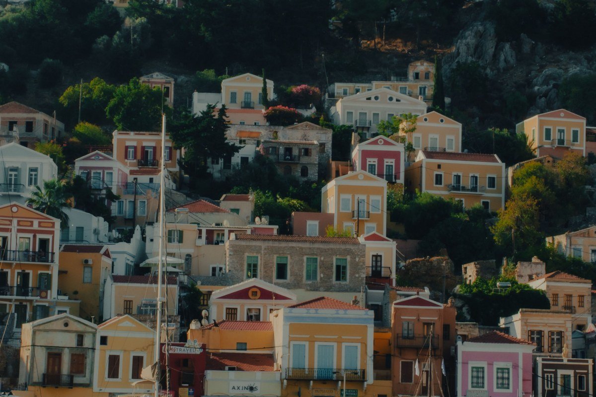 Halki island Nimporio harbor neoclassical mansions pastel facades Greece Dodecanese