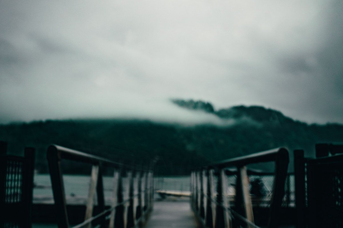 foggy golden-hour dock on Douglas Lake, Dandridge, Tennessee, with Smoky Mountain ridgeline behind
