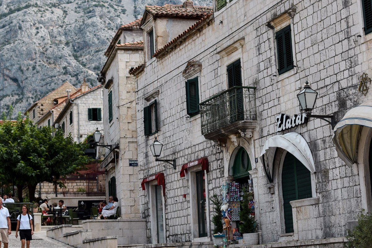 Hvar town's stone-paved Pjaca square at dawn, the 16th-century fortress overhead and the Adriatic beyond, photographed before the summer ferries arrive from Split