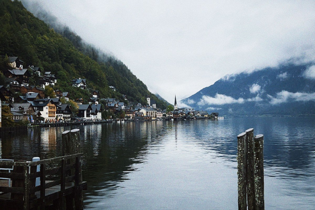 Hallstatt Austria misty morning lake reflection village and mountains fog