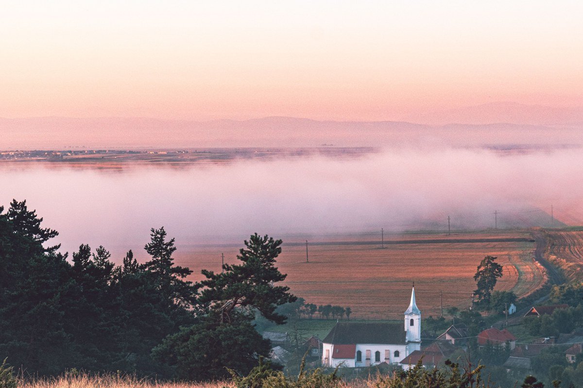 Transylvania Romania misty rolling hills villages fog at dawn Bran countryside