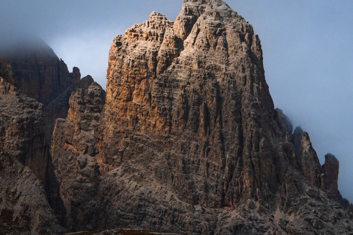 Dolomites Italy misty mountain pass autumn fog Passo Giau with dramatic peaks