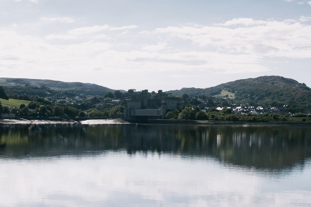 Conwy Castle Wales misty morning estuary fog medieval walls and river reflection