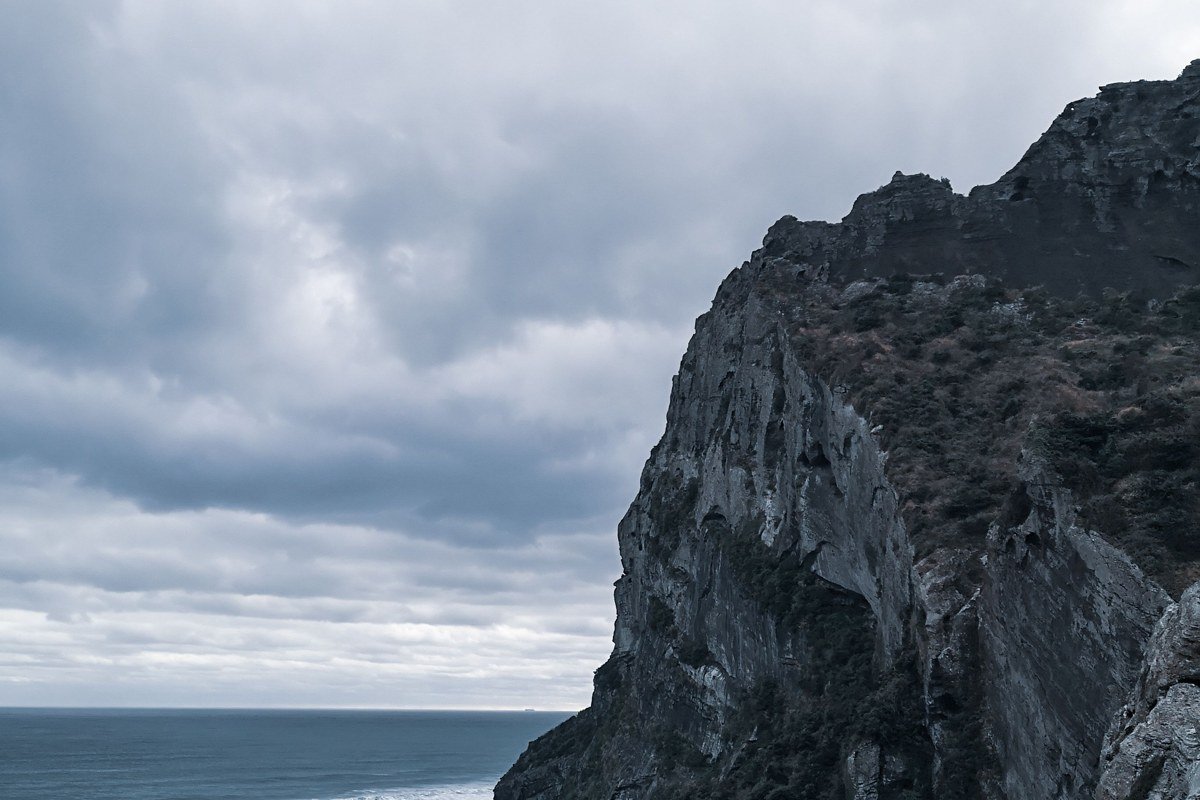 Cabo Froward Chile southernmost point mainland South America rocky headland stormy sky trekker silhouette