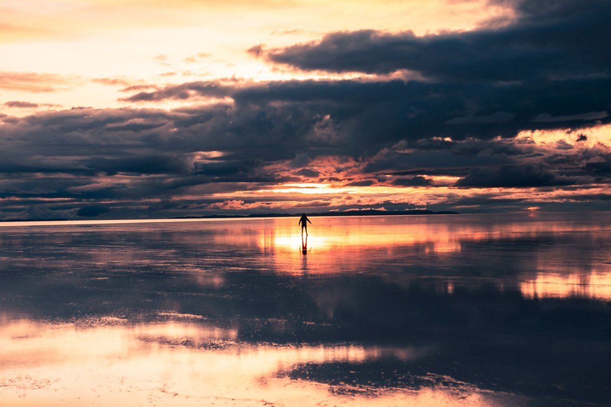 Salar de Uyuni Bolivia storm clouds dark sky reflection dramatic lightning wet season